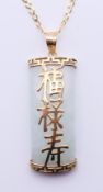 A jade pendant on a 9 ct gold chain. Pendant 3 cm high, chain 46 cm long.