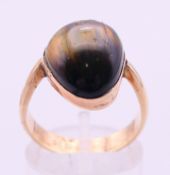 A 9 ct gold and tigers eye ring. Ring size P/Q.