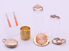 A quantity of yellow metal jewellery to include earrings, a locket pendant, two rings,