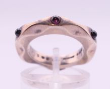 A Georg Jensen silver and garnet ring designed by Maria Berntsen. Ring size I.