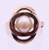 An unmarked 9 ct gold and pearl ring (with sizing bar Ring size M)