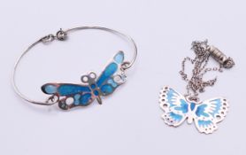 A Norman Grant silver and enamel butterfly bangle and a Norman Gant silver butterfly pendant on a