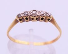 An 18 ct gold five stone diamond ring. 1.8 grammes. Ring size P/Q.