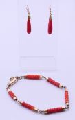 A coral bracelet and a pair of 18 ct gold coral drop earrings. Bracelet 21 cm long, earrings 2.