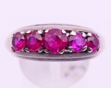 An unmarked white gold,(probably 14 ct) and ruby five-stone ring. 7.5 grammes total weight.