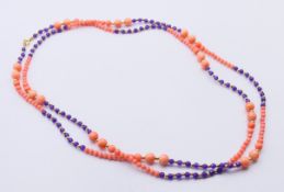A coral and amethyst bead necklace with a 9 ct gold clasp. 124 cm long.