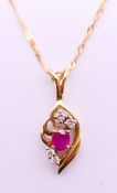 An 18 ct ruby and diamond pendant on an 18 ct gold chain. Pendant 2.5 cm high, chain 44 cm long. 3.
