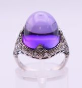 An Art Deco palladium, platinum and amethyst ring. Ring size L.