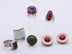 Five contemporary silver rings and a pair of silver clip-on earrings. Earrings 2.5 cm diameter.