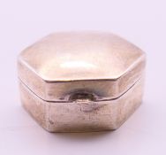 A silver hexagonal pill box. 2.5 cm x 2 cm, 1 cm high.