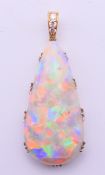 An unmarked gold opal and diamond drop pendant. 4.25 cm high including suspension loop.