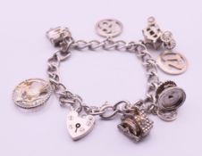 A silver charm bracelet with heart padlock clasp. Approximately 18 cm long. 34.9 grammes.