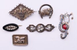 Various silver brooches to include a treble clef and music note brooch,