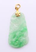 A jade pendant with an unmarked high carat gold suspension loop. Pendant 3.5 cm high.
