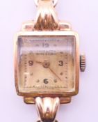 An Emka 9 ct gold cased ladies wristwatch on a 9 ct gold strap. Dial 1.
