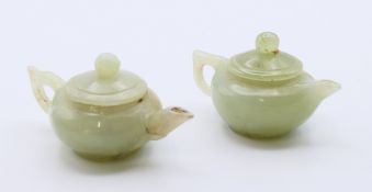 Two jade teapots. Each approximately 4 cm high.