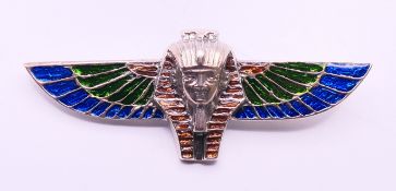 A silver brooch formed as a winged pharaoh mask. 7.5 cm x 2.75 cm.