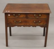 A 19th century mahogany three-drawer side table. 82 cm wide.