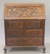 A Chinese carved wooden bureau. 91 cm wide.
