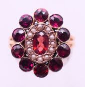 A 9 ct gold, garnet and seed pearl ring. Ring size P.