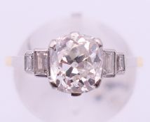 An 18 ct gold and platinum five stone diamond ring. The central stone spreading to approximately 1.