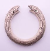 A Chinese snake bangle. 6 cm internal diameter, 1.25 cm wide.