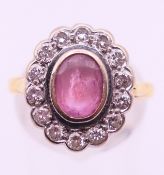An 18 ct gold and diamond flower head ring. Ring size N.