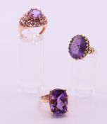 Two 9 ct gold and amethyst rings 17.8 grammes total weight and an 18 ct gold and amethyst ring. 5.