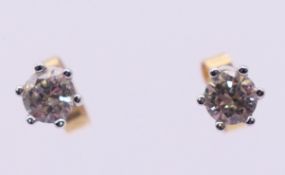 A pair of 18 ct gold diamond stud earrings. Approximately 0.5 cm diameter.