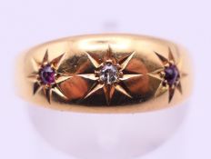 An 18 ct gold, diamond and ruby gypsy set ring. Ring size P/Q.