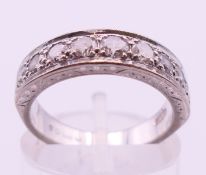 An 18 ct white gold and nine-stone diamond ring. Ring size K.