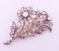 A Victorian unmarked diamond 'en tremblant' flower brooch. The largest stone approximately 0.