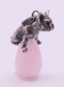 A silver and rose quartz dog and egg pendant. 3 cm high.