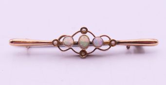 A Victorian unmarked 9ct gold opal and seed pearl bar brooch. 5 cm long. 1.8 grammes total weight.