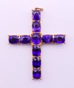 An 18 ct gold and amethyst cross pendant/brooch,
