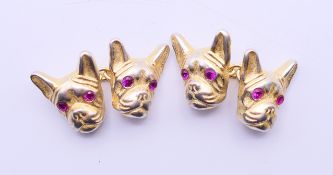 A pair of cufflinks bearing Russian marks formed as dog's heads. 1.5 cm high.