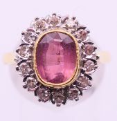 An 18 ct gold, diamond and pink stone ring. Ring size P/Q.