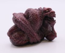 A netsuke formed as a dragon. 4 cm high.