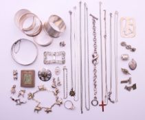A quantity of various silver, to include four napkin rings, bracelets, charms, a pair of cufflinks,