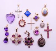 A quantity of various gold gem set pendants to include three 9 ct gold gem set cross pendants.