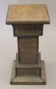 A rattan plant stand. 61 cm high.