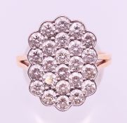 An unmarked gold diamond cluster ring. Ring size Q/R.