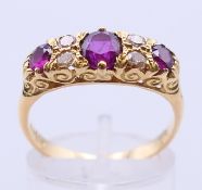 An 18 ct gold, diamond and ruby ring. Ring size P/Q.