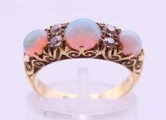 An 18 ct gold, opal and diamond ring, opals estimated weight 1.