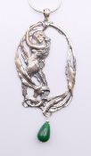 A silver and jade drop Art Nouveau style female figure surrounded by vines pendant on a silver