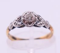 A gold, platinum and diamond solitaire ring. Ring size K/L.