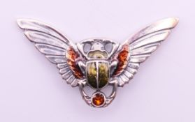 A silver brooch formed as a winged scarab beetle. 5.25 cm x 3 cm.
