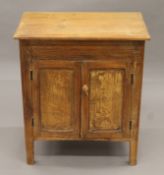 A pine side cupboard. 66 cm wide.