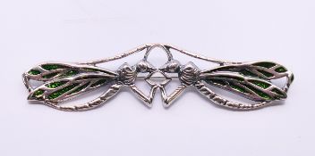 A silver double dragonfly brooch. 9 cm x 2.5 cm.