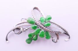 A 14 K white gold and jade-set brooch. 5.5 cm x 3.5 cm.